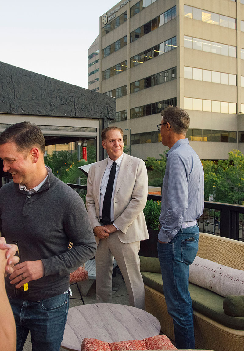 Jay discussing with others on rooftop